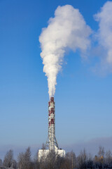 Smoke from a chimney against a blue sky