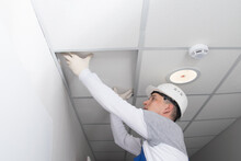 Master Of Communications Maintenance, Opens The Suspended Ceiling, For The Repair Of Lighting And Alarm Wiring