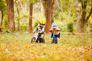 Wall Mural - Cheerful preschool kids outdoors on balance bikes