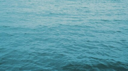 Sea water ripple surface top view, closeup. Nature background. Artistic landscape ocean dark texture. 4K footage.