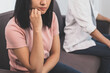 © KMPZZZ - Unhappy young asian couple fights on couch, relationship is in trouble. Different people are angry and use emotions at each other. Wife has an expression of disappointment and upset with her husband.