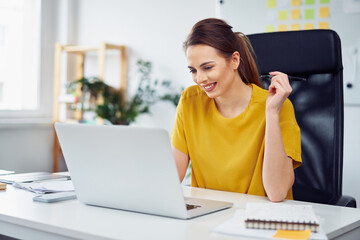 Businesswoman working on laptop in office