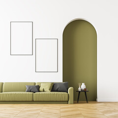 Bright living room interior with green sofa and two posters