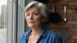© fizkes - Retirement problems. Worried depressed old age latin lady stand by window look away troubled with bad health loneliness. Upset mature hispanic grandma miss children husband lost in sad heavy thoughts