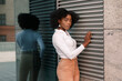 © BartLoveyou - dark-skinned attractive woman near the wall