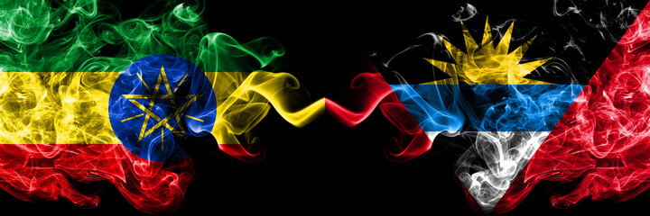 Ethiopia, Ethiopian vs Antigua and Barbuda, Antiguan and Barbudan smoky mystic flags placed side by side. Thick colored silky abstract smoke flags.