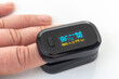 © sir270 - Portable black pulse oximeter on a white background. Monitoring the oxygen level at home. Covid-19, a heart rate health tester is used to measure the air in the lungs.