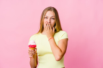 Wall Mural - Young russian woman eating an ice cream isolated yawning showing a tired gesture covering mouth with hand.