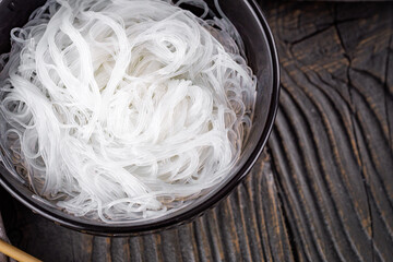 boiled glass noodles on a white wooden rustic background