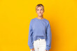 © luismolinero - Young Russian woman isolated on yellow background having doubts while looking up