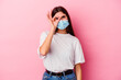 © Asier - Young caucasian woman wearing a mask for virus isolated on pink background excited keeping ok gesture on eye.