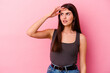 © Asier - Young caucasian woman isolated on pink background looking far away keeping hand on forehead.