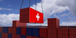 © brainwashed 4 you - A freight container with the swiss flag hangs in front of many blue and red stacked freight containers - concept trade - import and export - 3d illustration