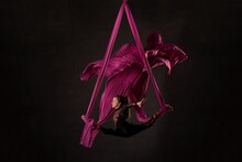 Woman Performing Acrobatic Dance On Aerial Silks