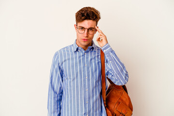 Wall Mural - Young student man isolated on white background pointing temple with finger, thinking, focused on a task.