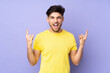 © luismolinero - Arabian handsome man over isolated background making horn gesture