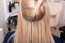 Professional Blonde Hair Extension In Hairdressing Salon. Close-up View Of Strands And Capsules.