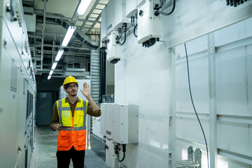 Fototapete - Portrait of electrician engineer use tablet computer taking notes at control room in factory.