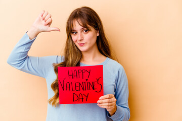 Wall Mural - Young caucasian woman holding a Happy Valentines day isolated feels proud and self confident, example to follow.