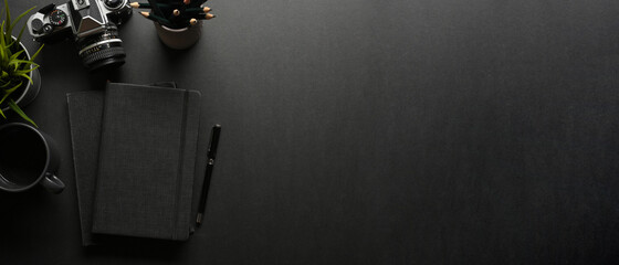 Wall Mural - Dark creative workspace with notebook, pen, camera and copy space, creative mock up scene