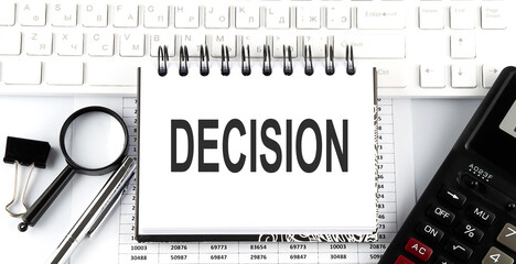 Poster - White notebook with text DECISION on white keyboard with calculator,magnifier and pen