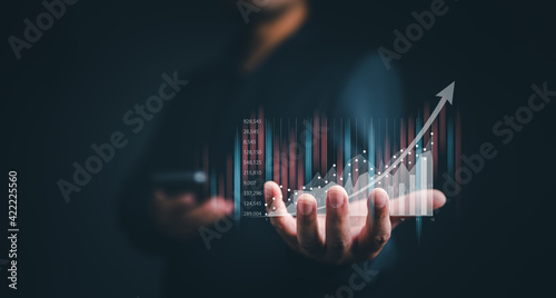 Fototapeta na szkło planning and strategy, Stock market, Business growth, progress or success concept. Businessman or trader is showing a growing virtual hologram stock, invest in trading.