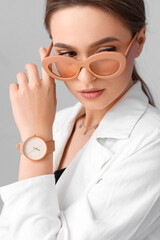 Sticker - Woman with stylish wrist watch on light background