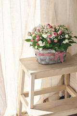 Poster - Flowers bouquet in basket against curtains