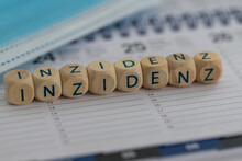 German Word For Incidency (Inzidenz) With Surgical Mask On A Calendar