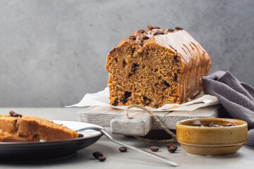 Sticker - Coffee Plumcake with chocolate pieces. Moka coffee added to the dough and to the sugar icing. Selective focus. Copy space.