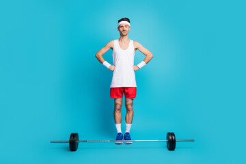 Wall Mural - Full body photo of young sportsman confused hesitate barbell workout gym isolated over blue color background