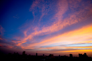 Wall Mural - Sunset sky with city in the shadow