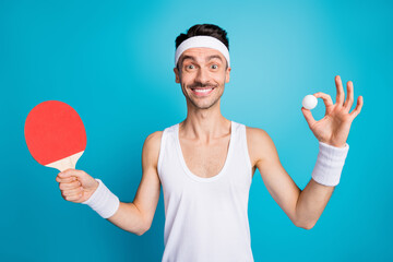 Poster - Photo of young sportsman happy positive smile play ping pong hold tennis ball raquete isolated over blue color background