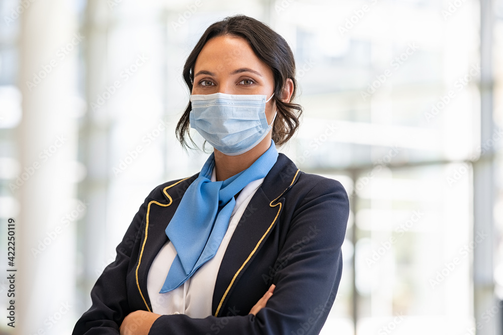 Air hostess wearing face mask during virus pandemic - obrazy, fototapety, plakaty 