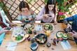 © Alessandro Biascioli - Young people taking food pictures with mobile smartphone to share on social media while having healthy meal in bar restaurant - Youth generation z and technology concept