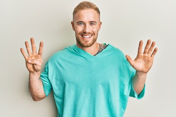 Wall Mural - Young caucasian man wearing casual clothes showing and pointing up with fingers number nine while smiling confident and happy.