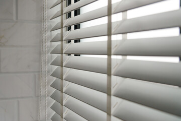 Wall Mural - Close-up open venetian blinds. lighting range control sunlight coming from a window. decoration interior. Modern jalousie.