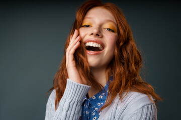 Wall Mural - Young ginger joyful woman laughing and looking at camera