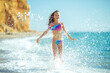© nuzza11 - Child girl runs on the waves. Rest by the sea, fun outdoors. High quality photo.