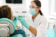 © Drobot Dean - European mid dentist woman in face mask working in dental clinic