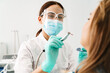 © Drobot Dean - European mid dentist woman in face mask working in dental clinic
