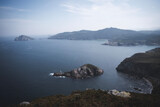 Fototapeta Niebo - small island near a coast with cliffs