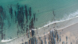 Fototapeta Niebo - aerial view of the beach with some lines of rocks
