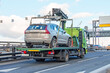 © aapsky - Hatchback car loaded onto a tow truck ready for transport.