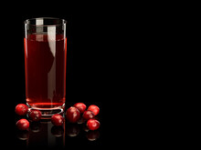 Glass Filled With Cranberry Berry Juice And Scattering Of Berries Of Cranberry