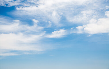 Poster - Blue sky background with white fluffy clouds in sunny day.