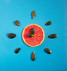 Wall Mural - Clock made of grapefruit and leafs. Time for breakfast. Creative summer fruit idea.