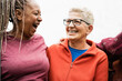 © DisobeyArt - Happy senior women from different ethnicities laughing together outdoor - Multiracial mature friends having fun - Joyful elderly lifestyle - Focus on right female face
