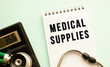 © Ihar - Notepad with text MEDICAL SUPPLIES, calculator and stethoscope on white background.