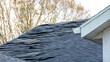 old asphalt roof shingles on house roof